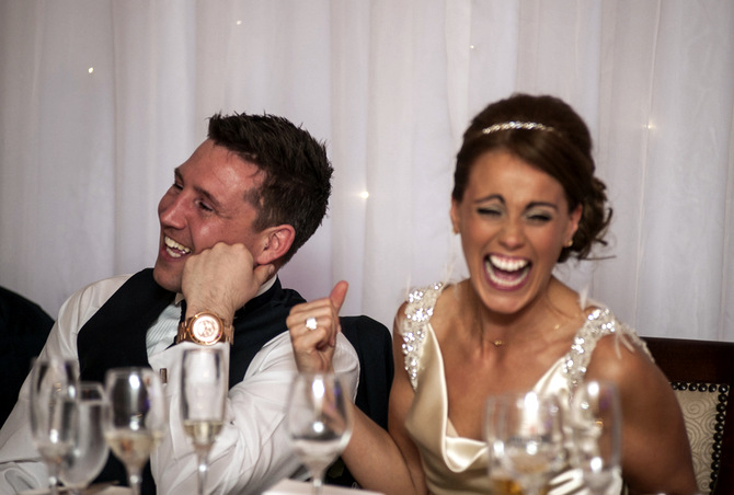 bride laughing at top table